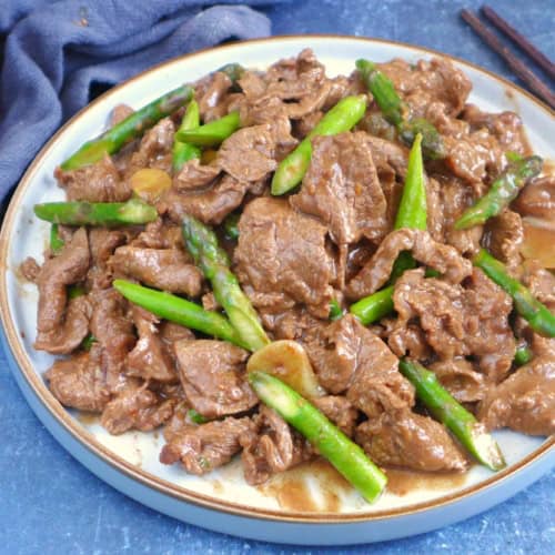 a plate of Sha Cha Beef with asparagus.