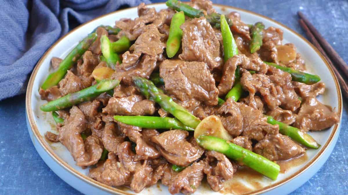 a plate of Sha Cha Beef with asparagus.