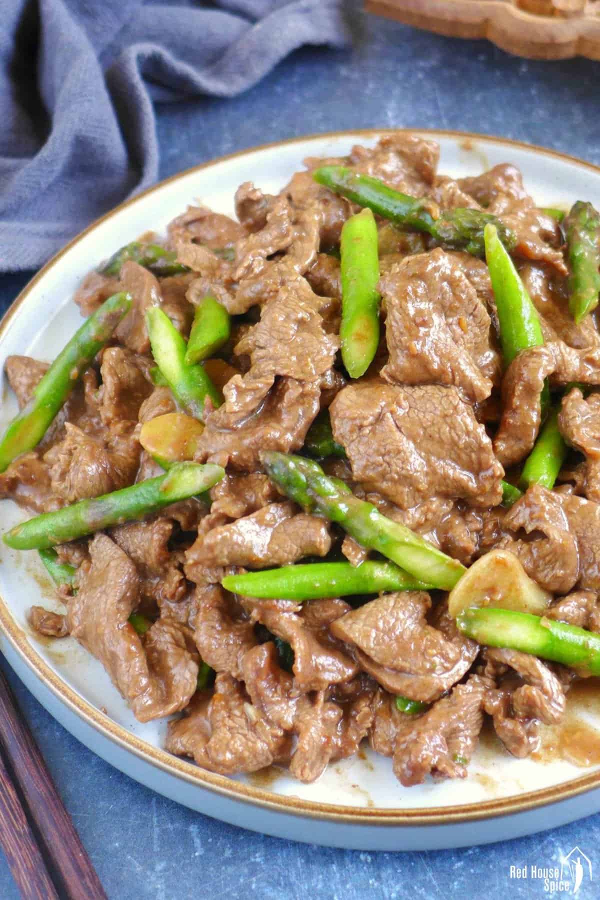 a plate of Sha Cha Beef with asparagus.
