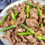 a plate of Sha Cha Beef with asparagus.