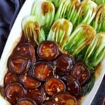 braised shiitake mushrooms over blanched bok choy with overlay text that says mushroom with Bok Choy