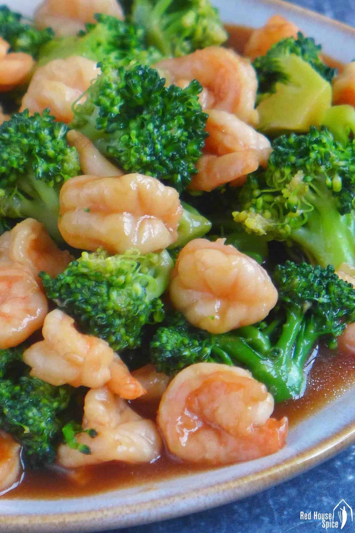 stir-fried shrimp and broccoli with brown sauce.