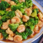 stir-fried shrimp and broccoli on a plate.