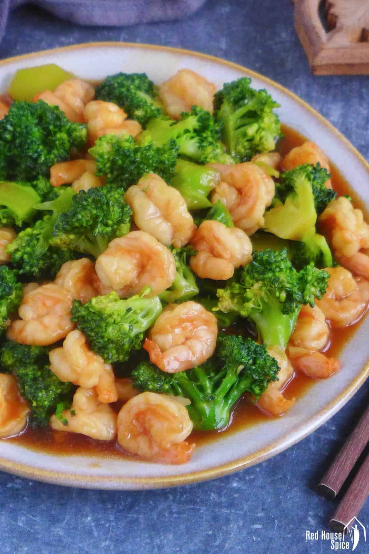 stir-fried shrimp and broccoli on a plate.