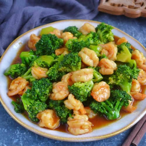 stir-fried shrimp and broccoli on a plate.