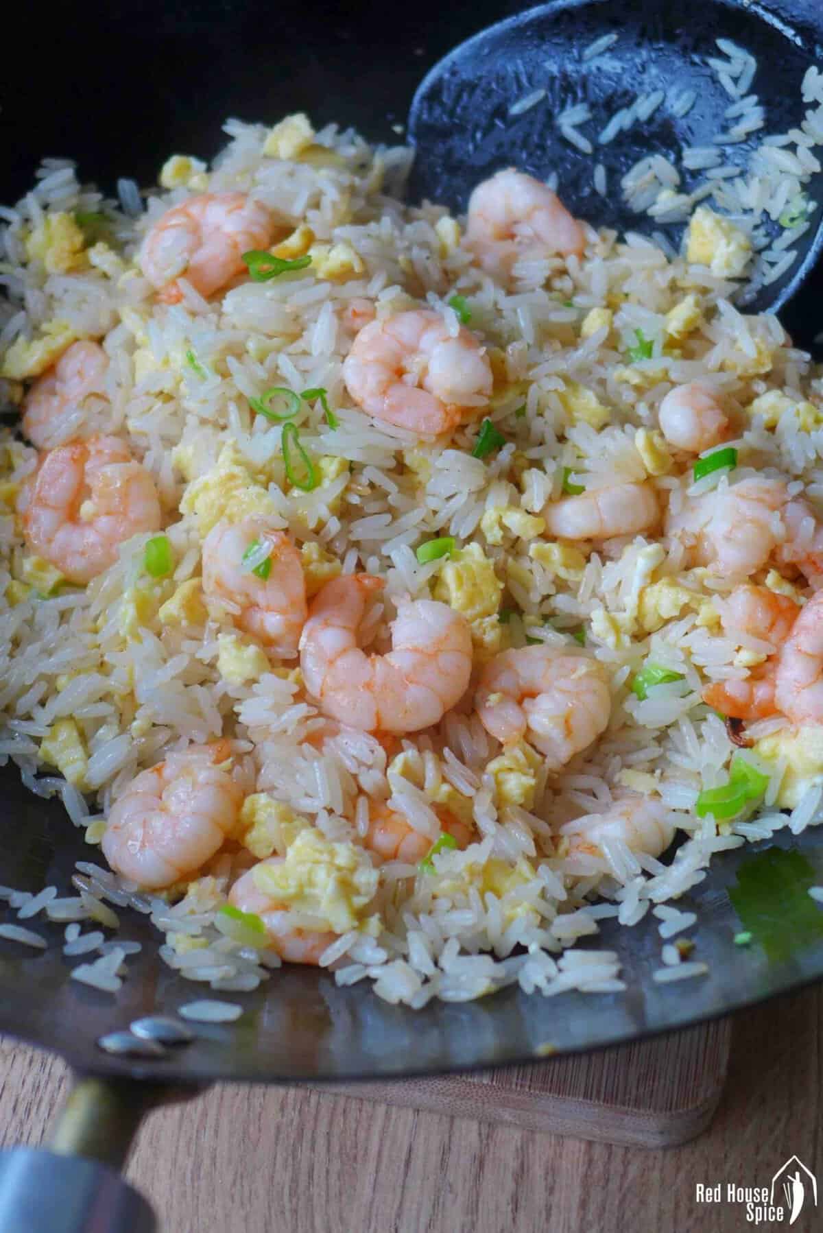 shrimp fried rice in a wok.