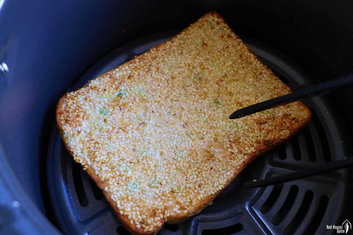 A piece of sesame shrimp toast in an air fryer