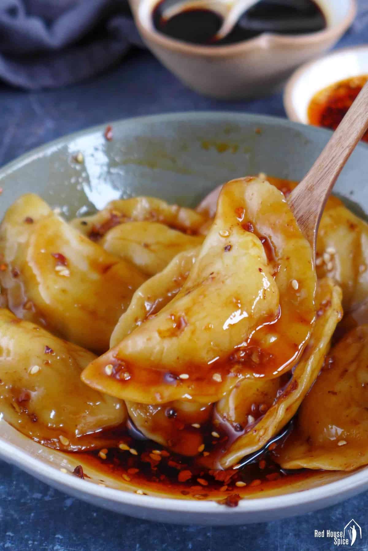 A Sichuan dumpling in a spoon.