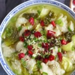 a bowl of Suan Cai Yu, Sichuan fish with sour vegetable with overlay text that say sichuan fish soup.