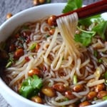 chopsticks picking up glass noodles.