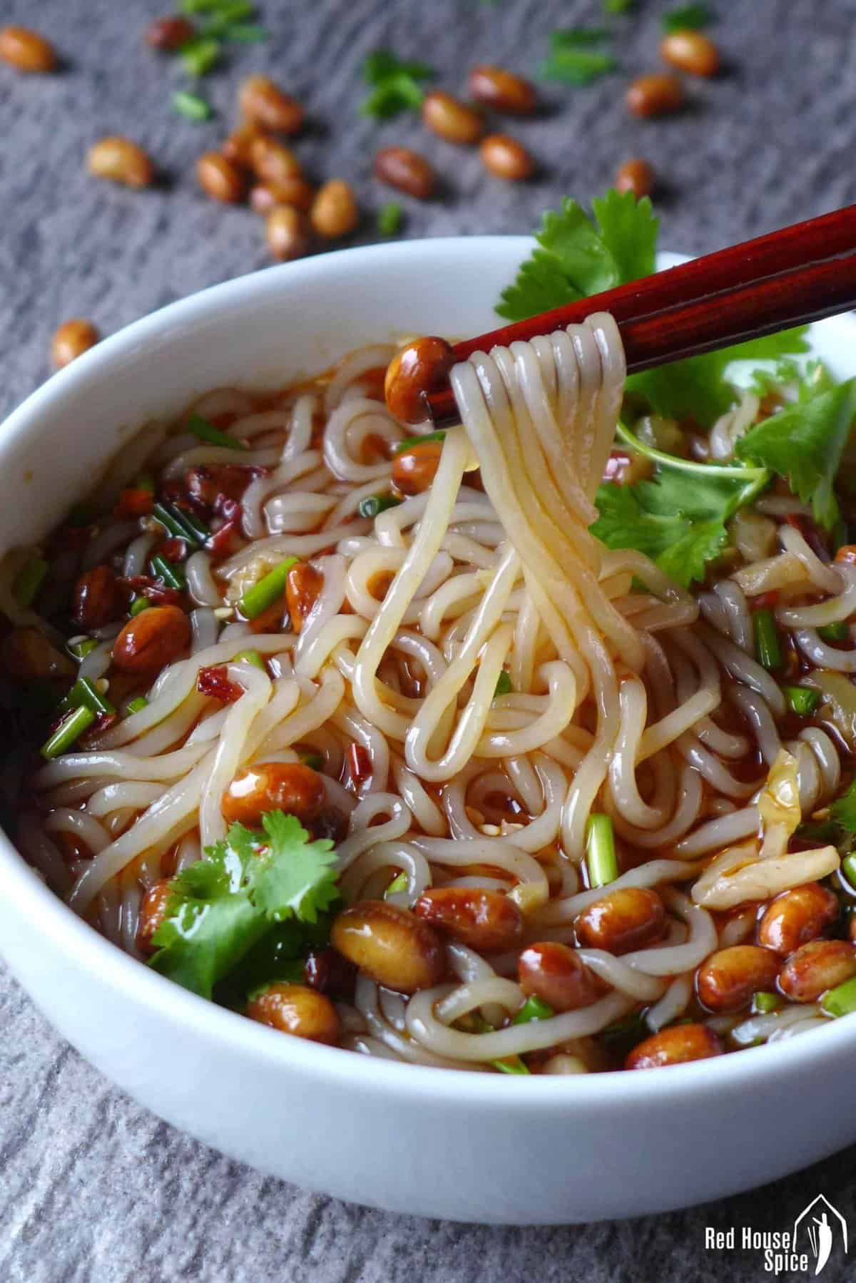 chopsticks picking up glass noodles.