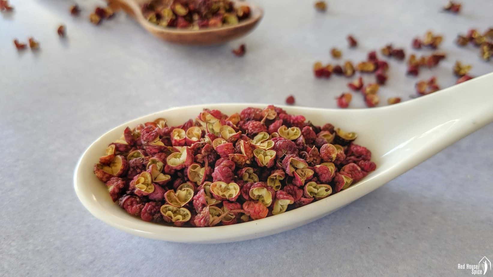 Whole Sichuan pepper in a spoon