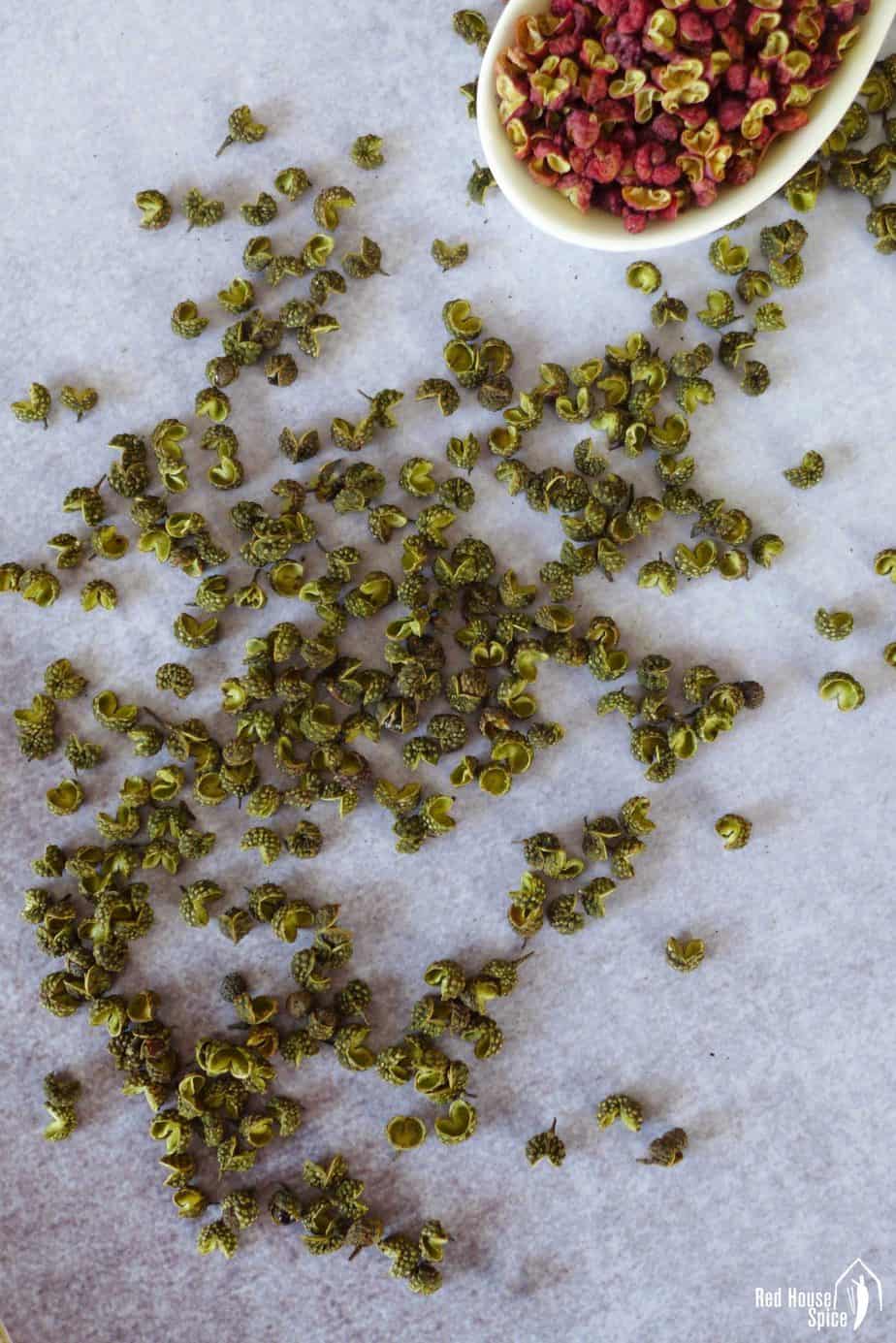 Green Sichuan pepper on a surface.