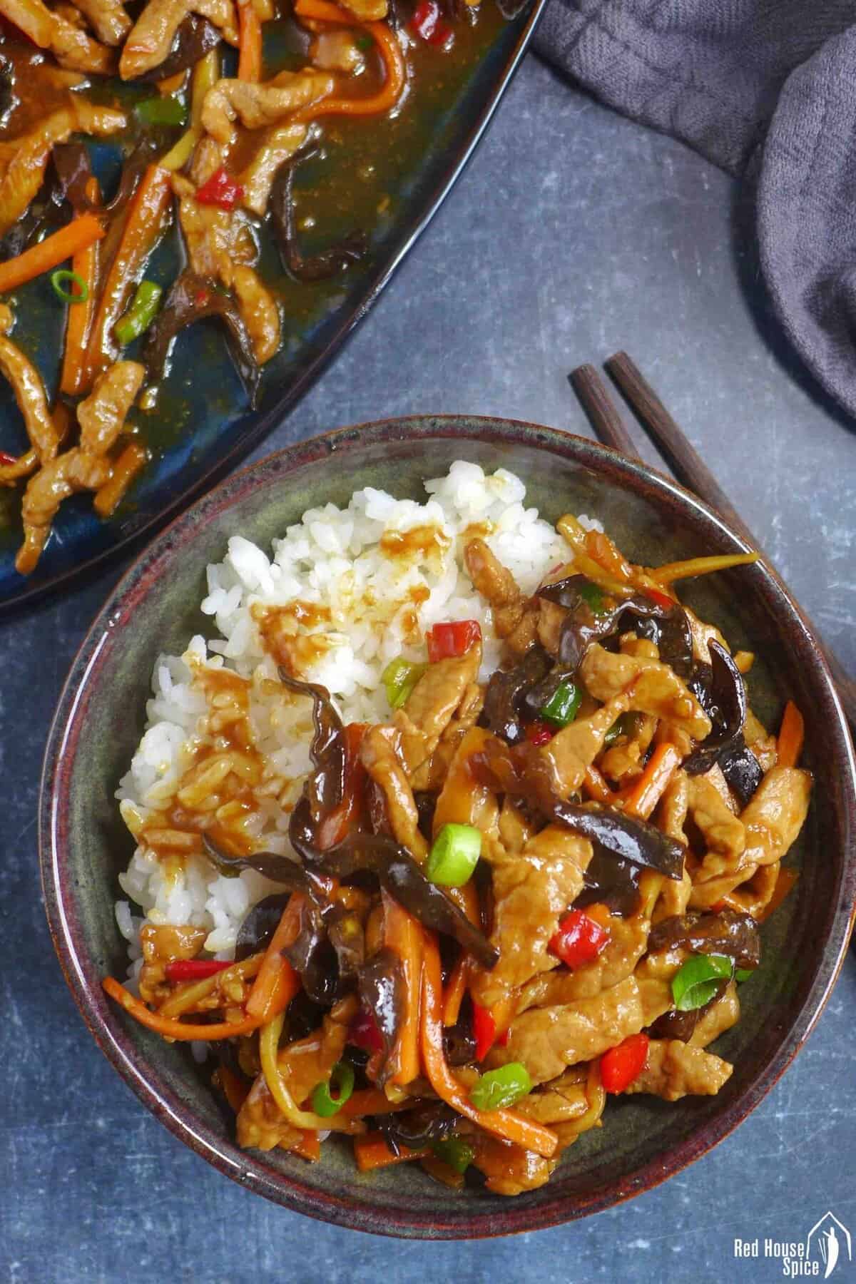 Sichuan Shredded Pork with garlic sauce over rice in a bowl.