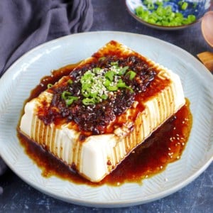 a block of silken tofu with scallion and soy dressing