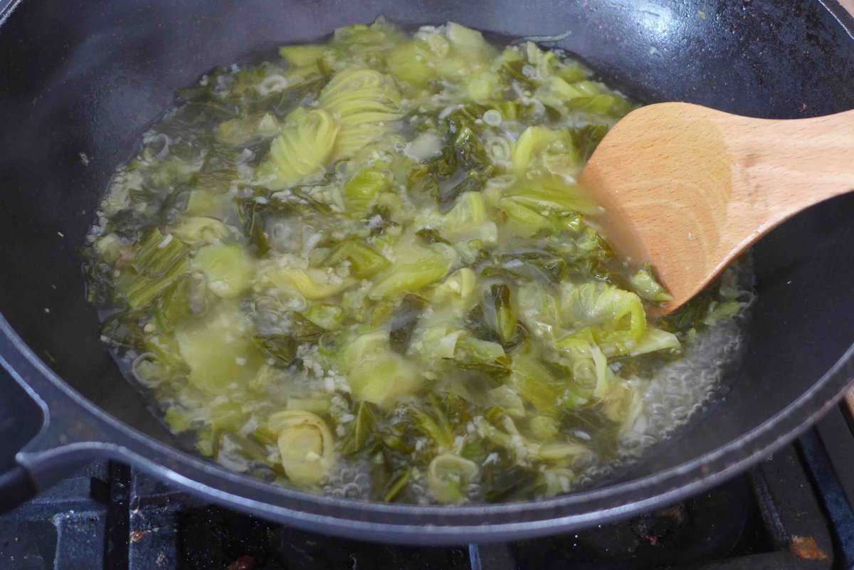 simmering soup with pickled mustard greens.