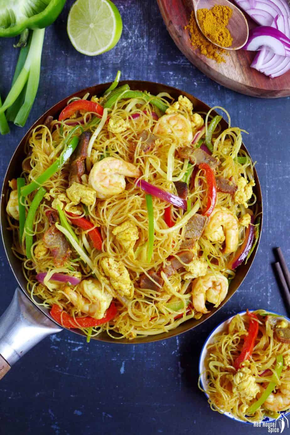A wok packed with Stir-fried Singapore Mei Fun