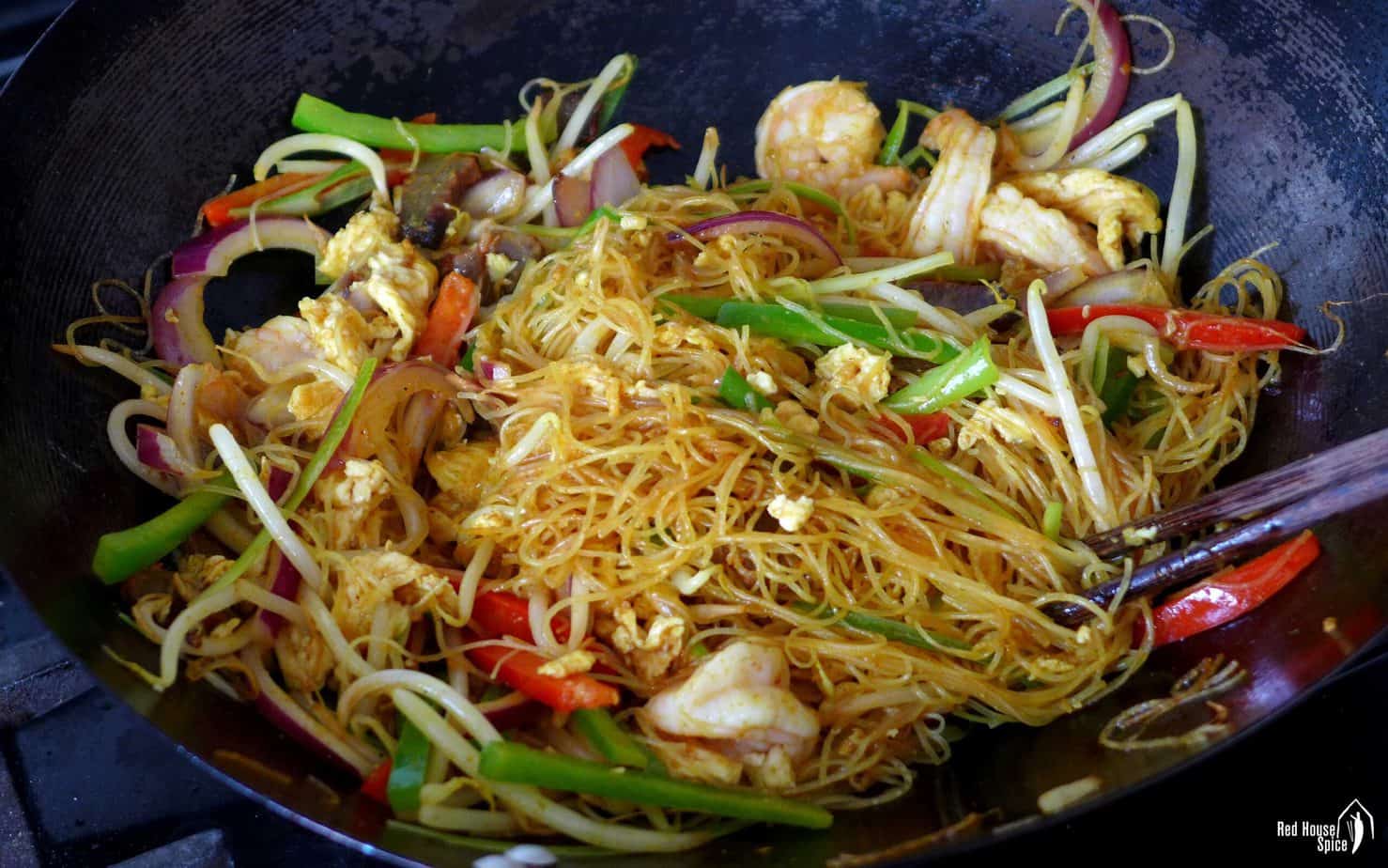 Stir-fried Singapore Noodles in a wok