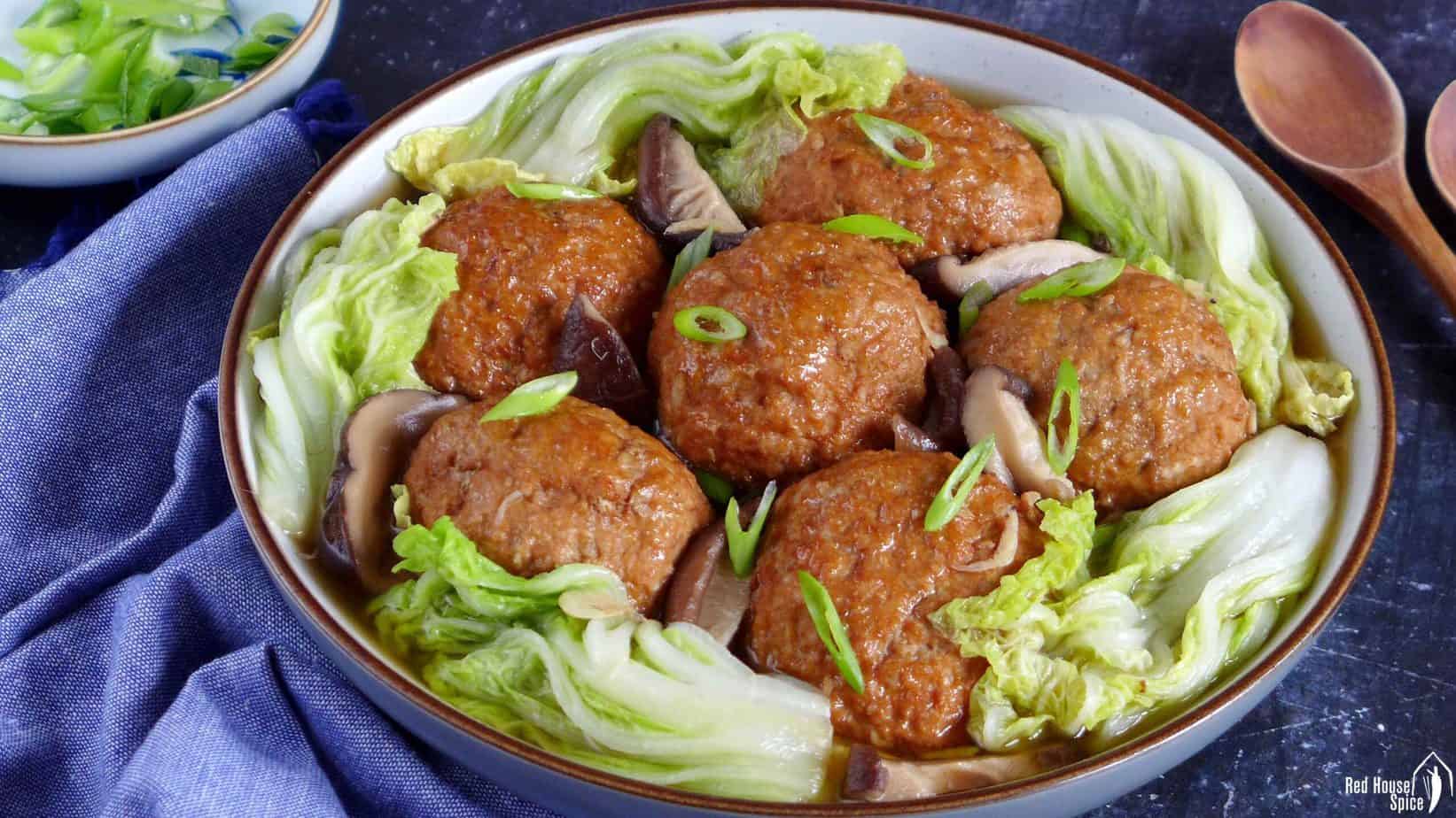 Chinese lion's head meatballs surrounded by Napa cabbage leaves