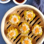 six cooked Siu Mai in a bamboo steamer.