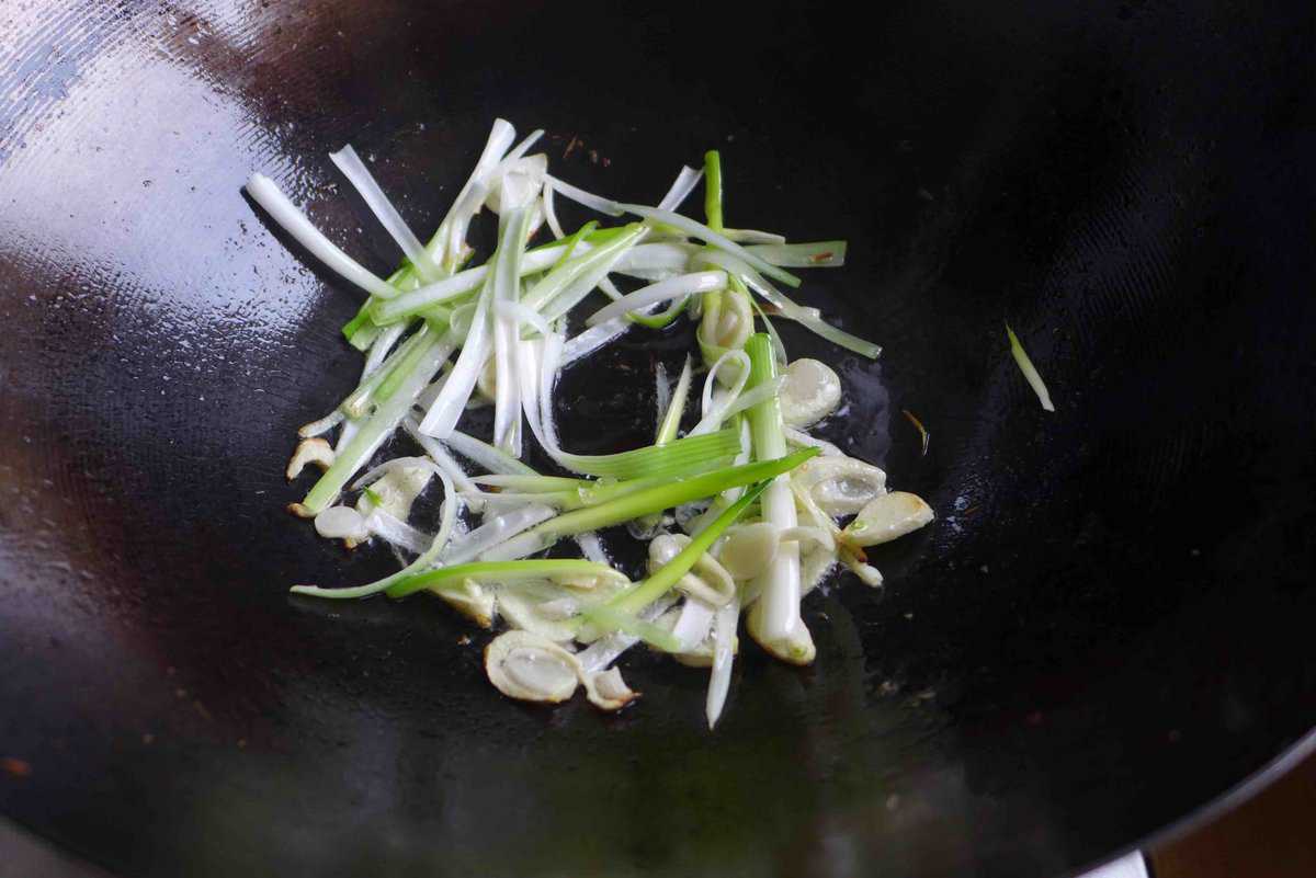 sizzling scallions and garlic in oil.