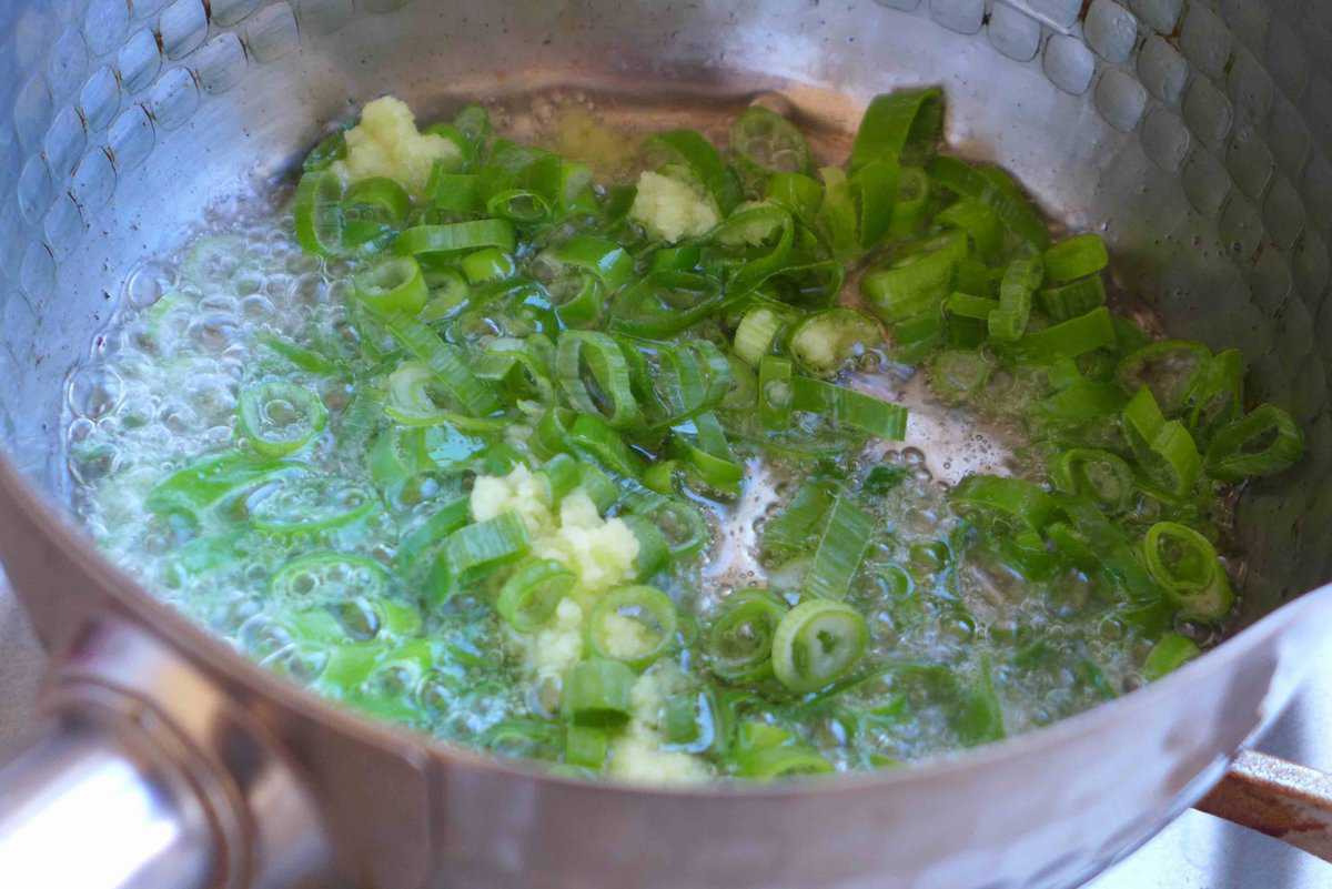 sizzling chopped scallion greens and ginger.