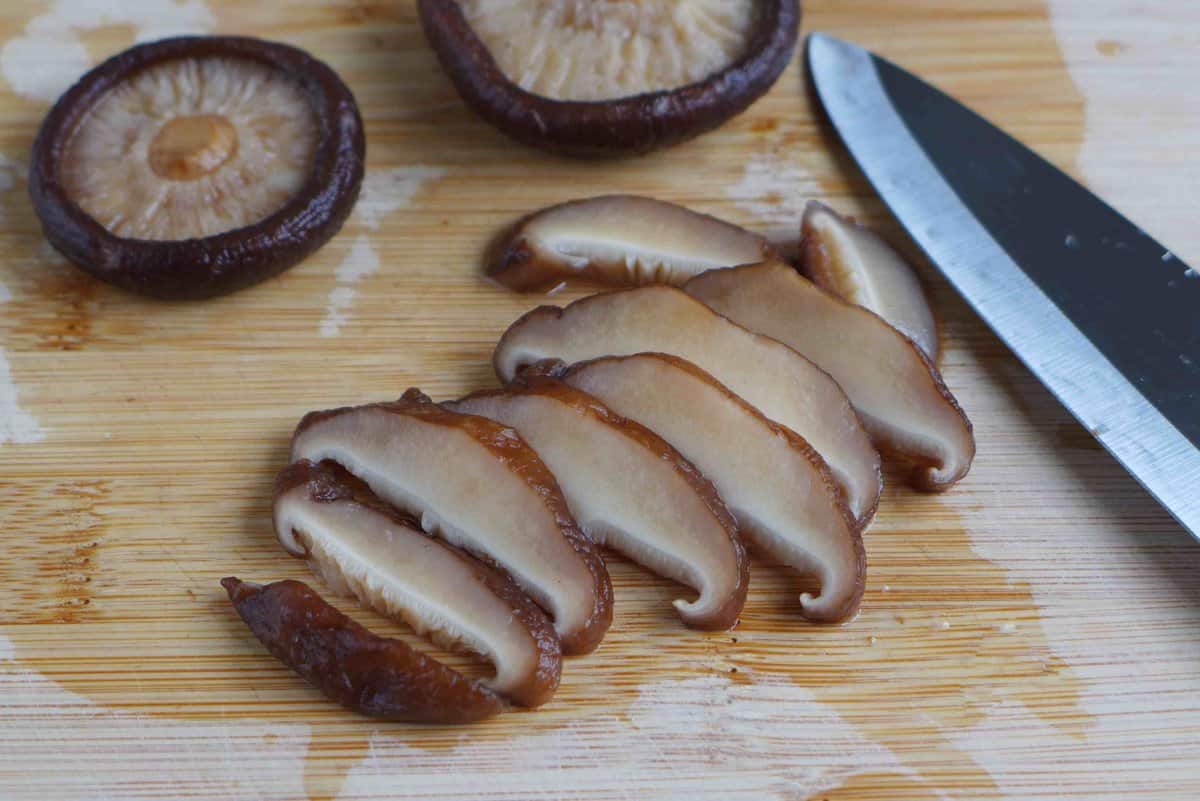 slicing shiitake mushrooms.