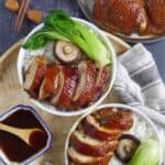 Soy sauce chicken served in rice bowls with vegetables