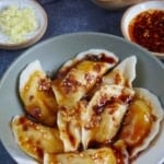 boiled dumplings seasoned with sweet soy sauce and chili oil.