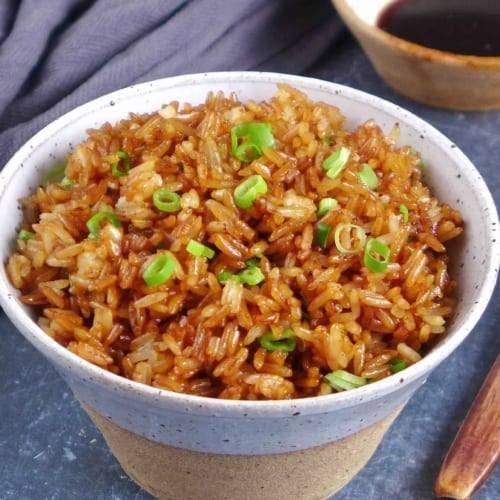 Chinese soy sauce fried rice in a bowl.