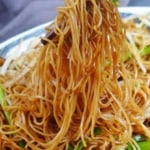 pulling noodles with chopsticks with overlay text that says soy sauce noodles.