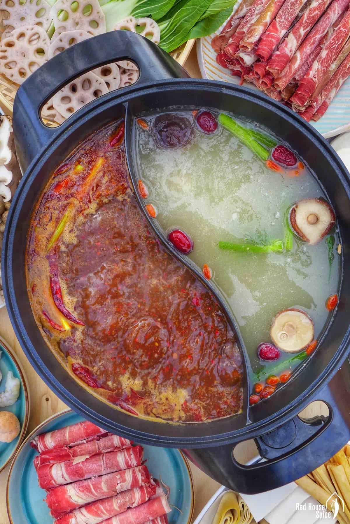 a divided pot filled with spicy and mild broth