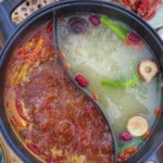a divided pot filled with spicy and mild broth with overlay text that says homemade hotpot broth