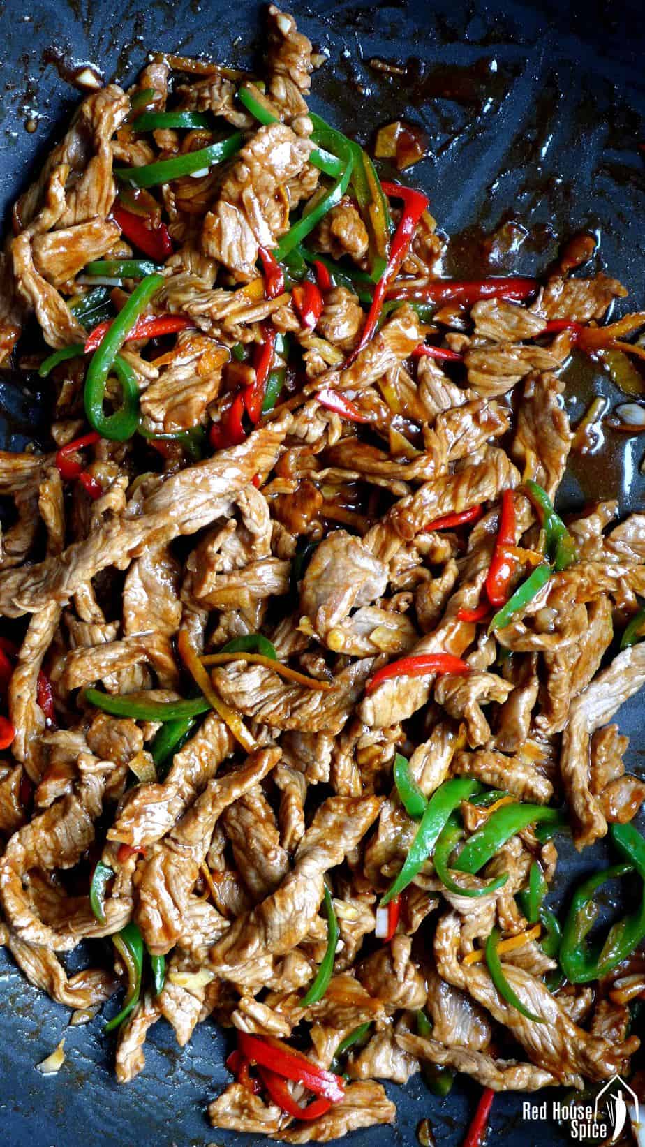 Beef strips and chillies in a wok