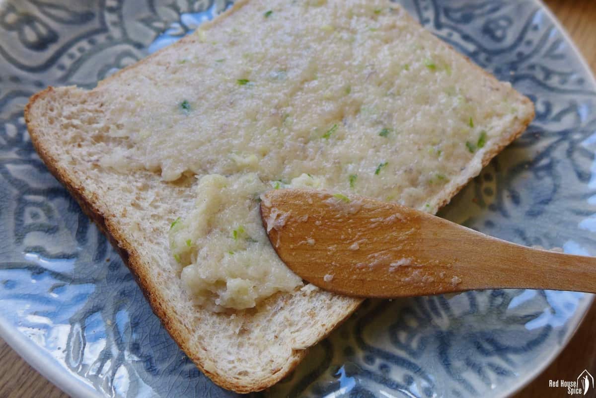 Spreading shrim.p paste over a piece of toast