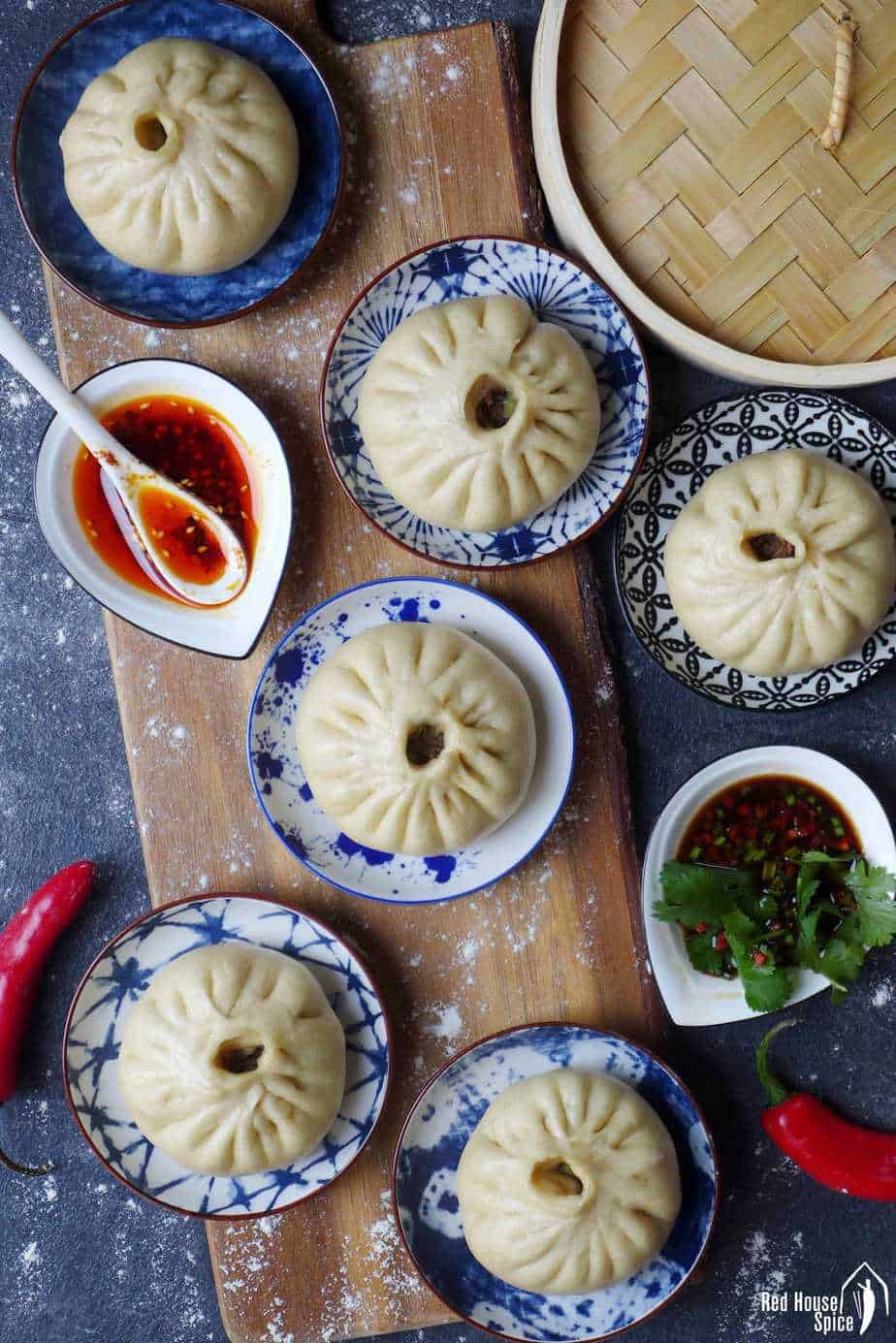 Steamed bao buns in individual plates.