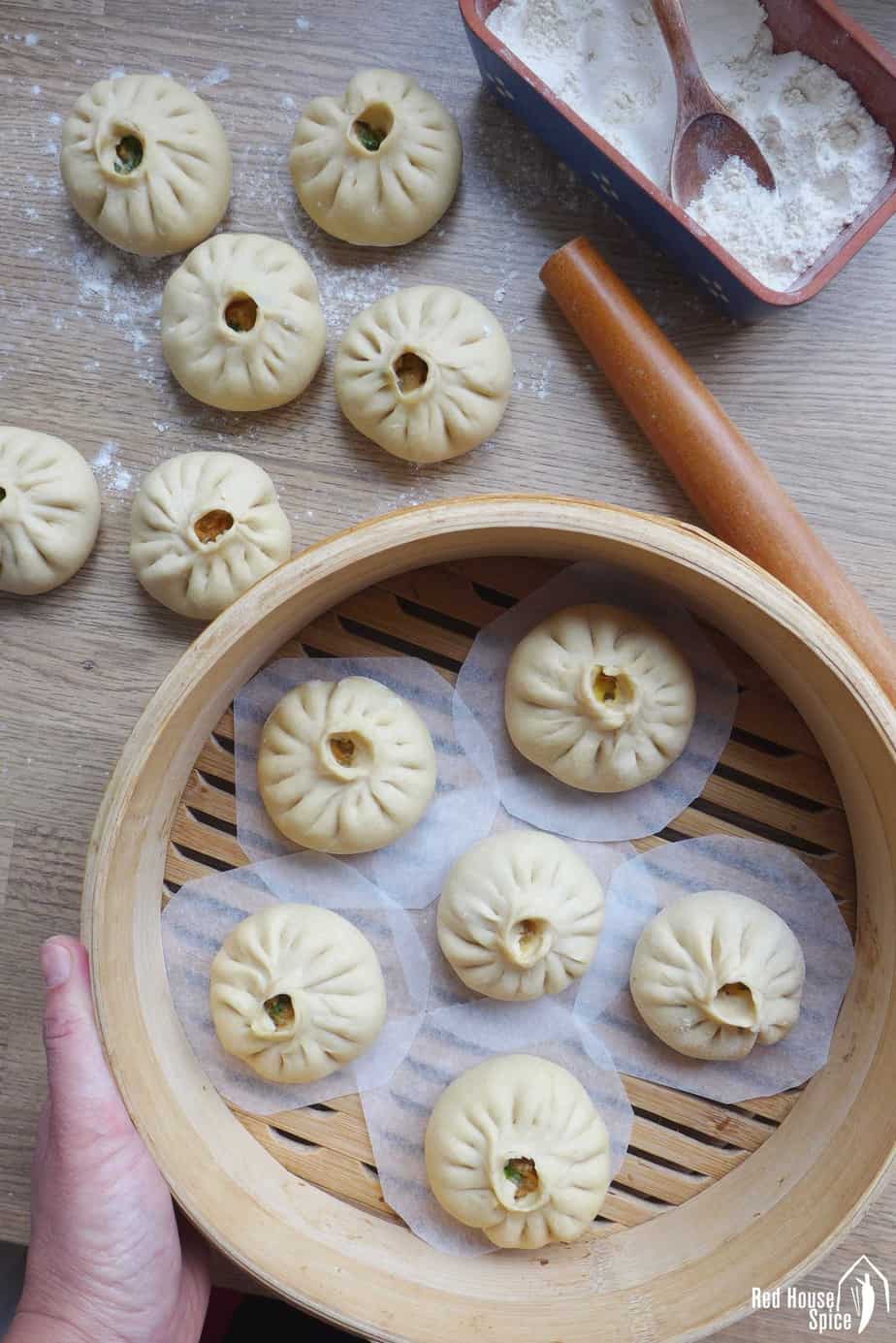 Freshly assembled bao buns ready to be steamed.