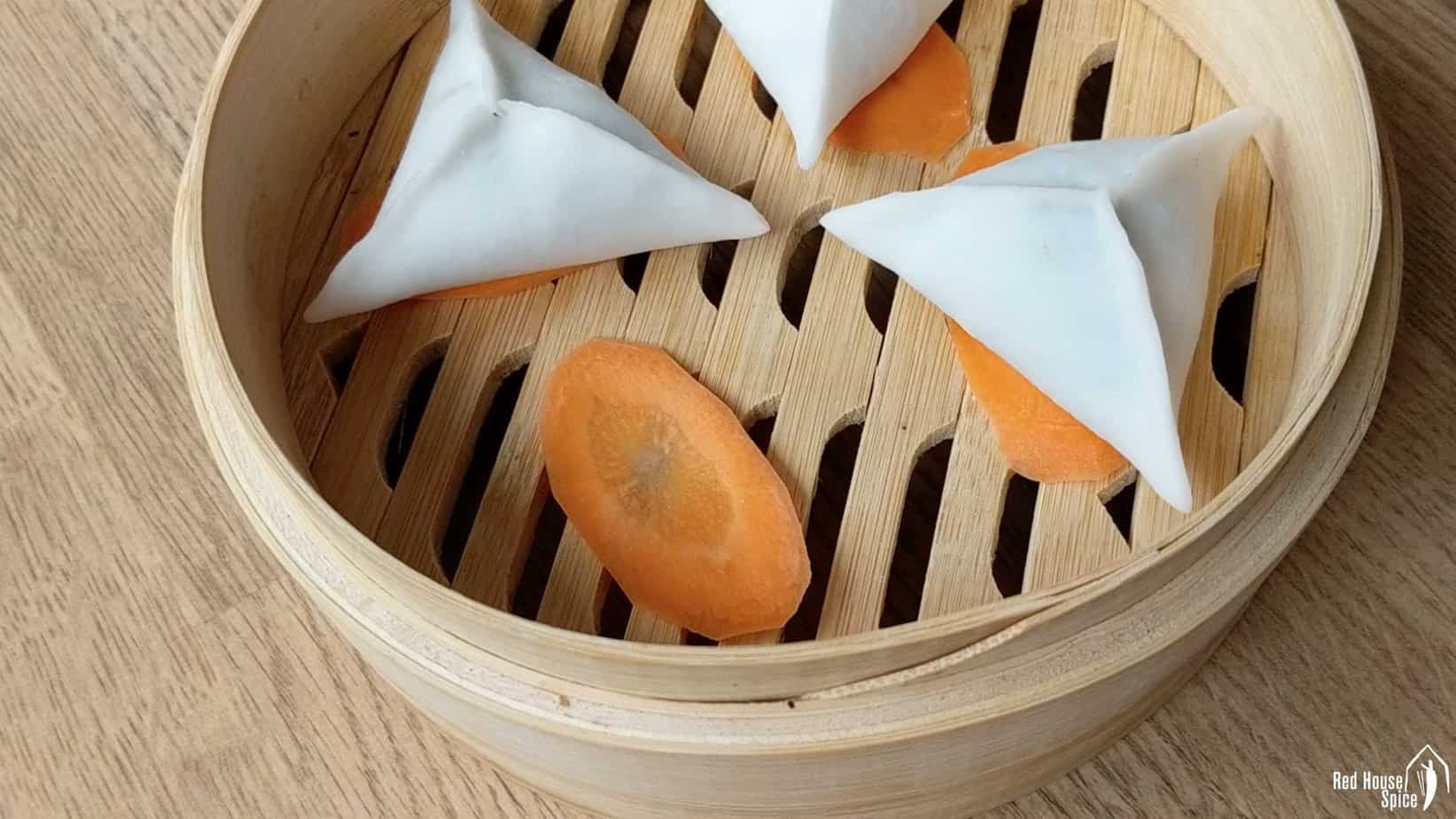 Dumplings over slices of carrot