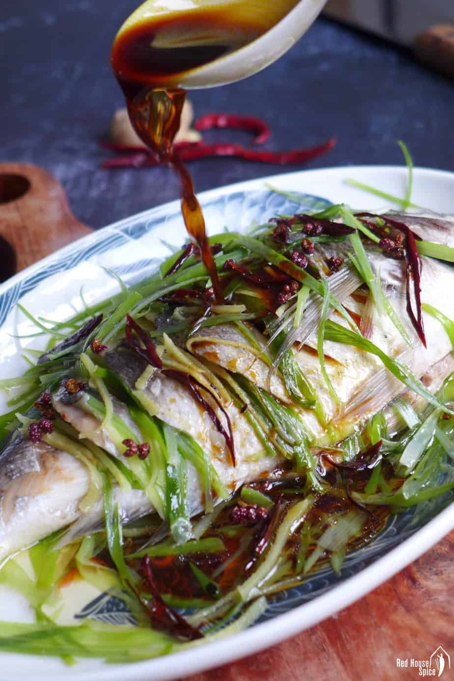 Pouring sauce over steamed fish