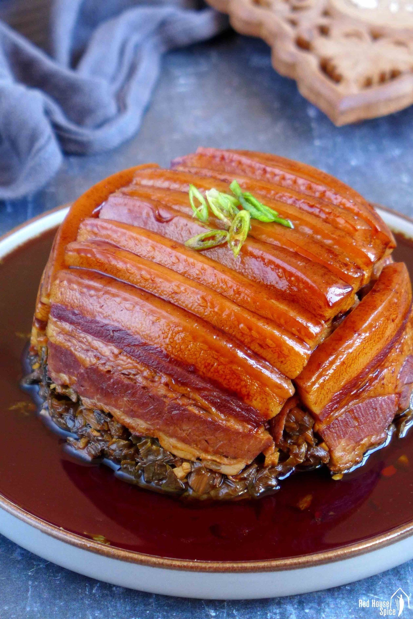 steamed pork belly over preserved mustard with sauce.