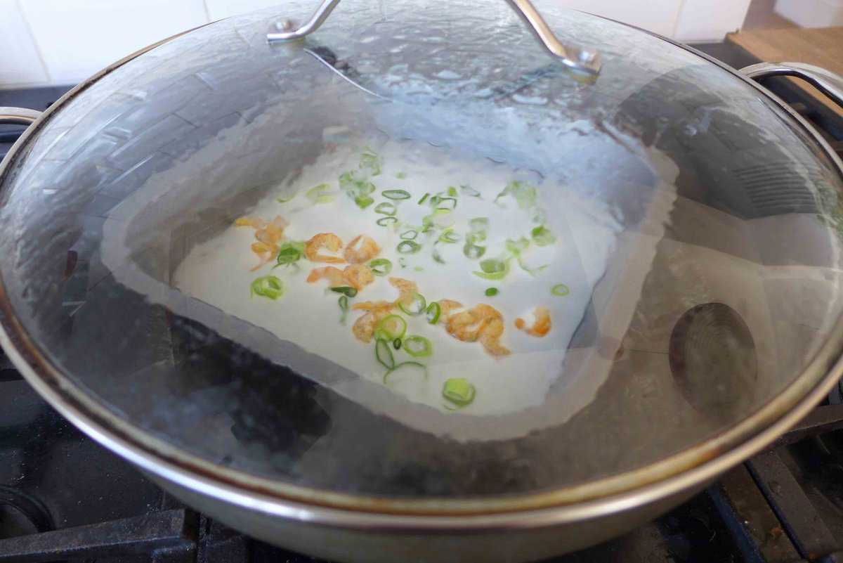 steaming Cheung fun in a wok