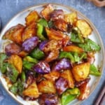 A plate of stir-fried eggplant, potato and pepper.