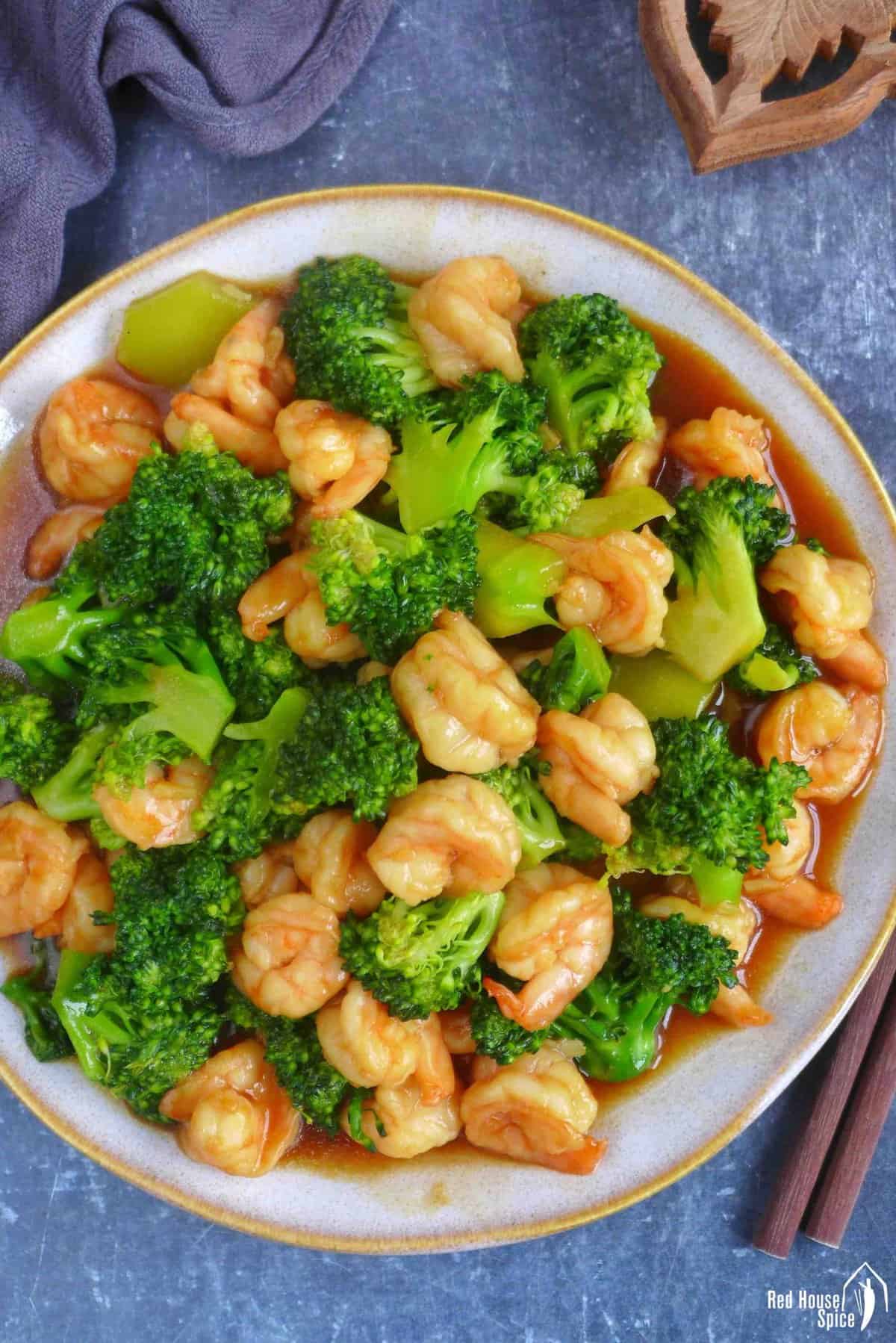 stir-fried shrimp and broccoli on a plate.