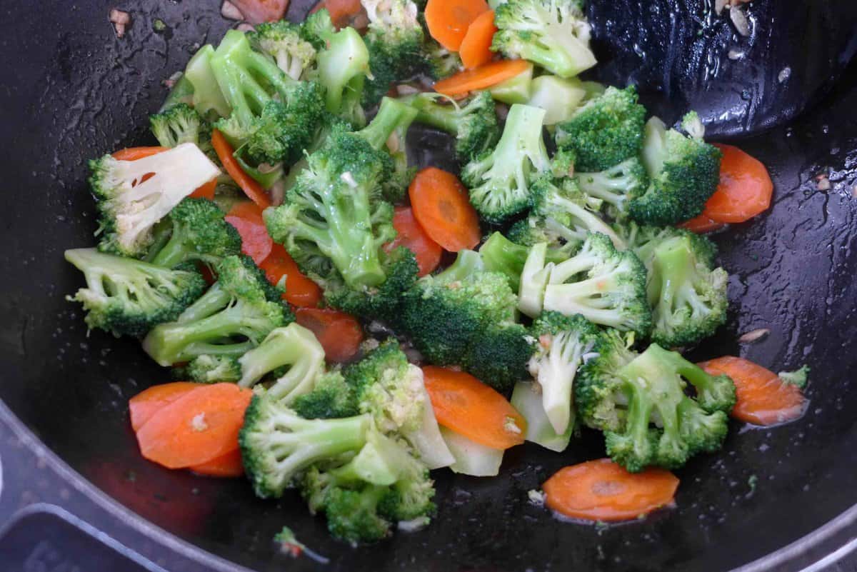 stir-frying broccoli and carrot.