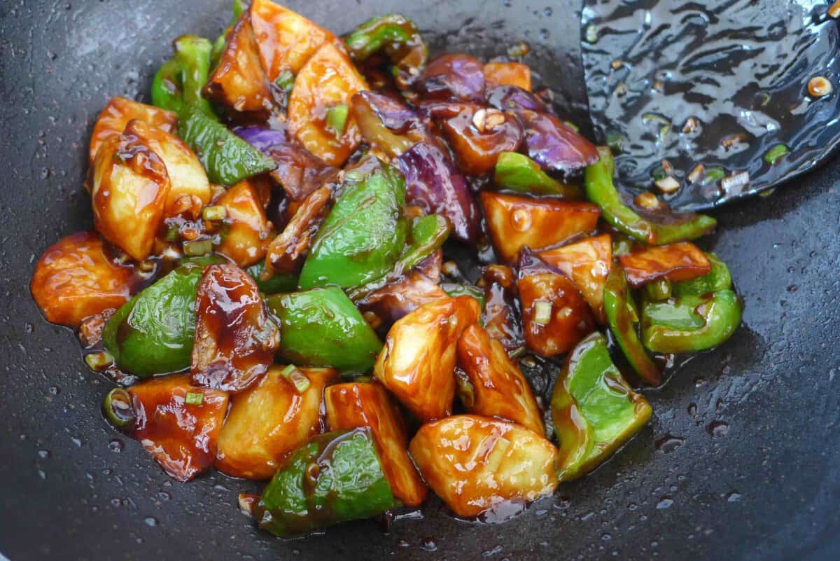 stir frying eggplant, potato and pepper in sauce.