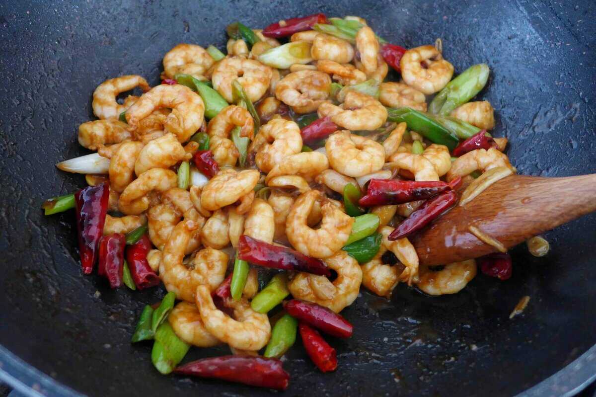 stir-frying Kung Pao Shrimp.