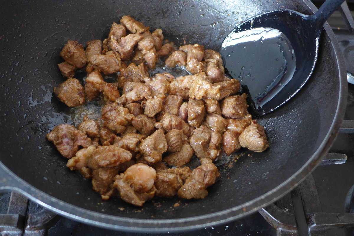 searing lamb cubes in oil.