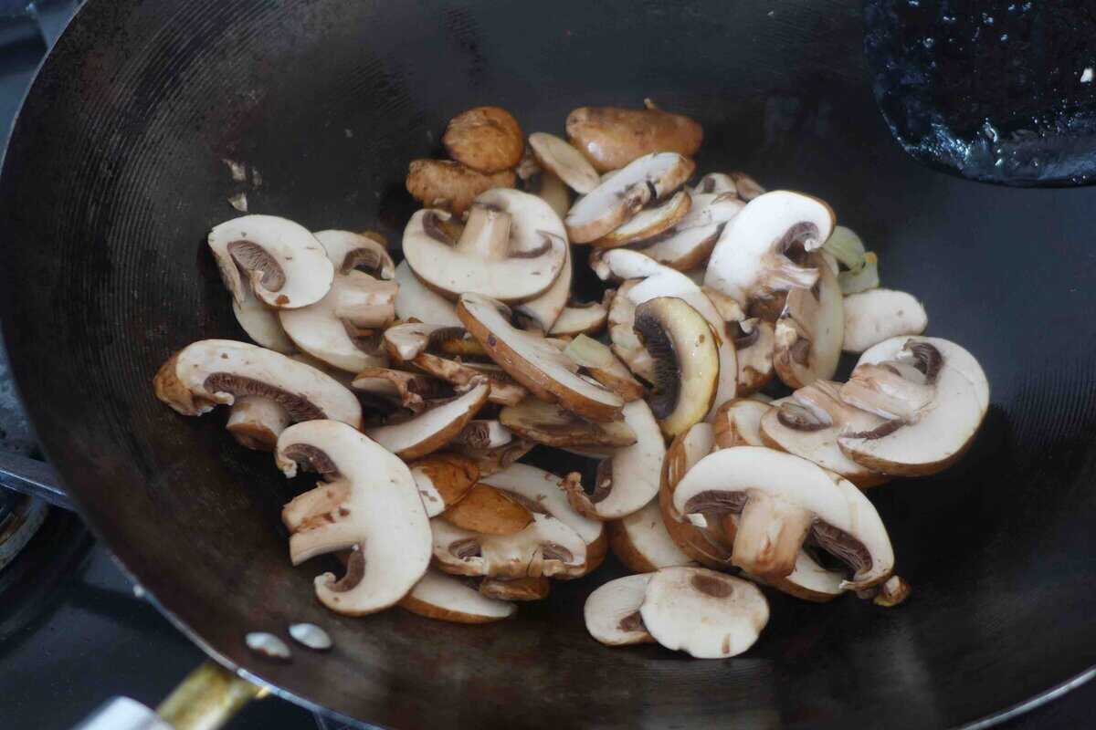Stir-frying mushrooms.