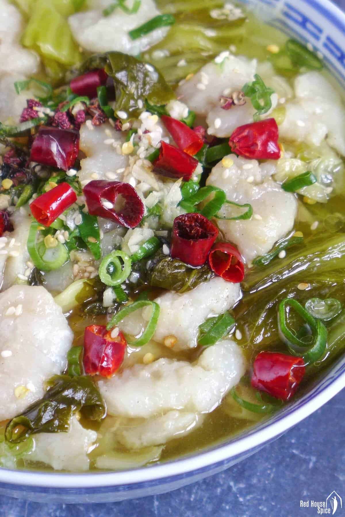 fish slices in a hot broth with pickled mustard greens.
