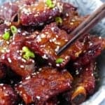 Chinese Sweet and sour ribs with a pair of chopsticks with overlay text that says Sweet and sour ribs